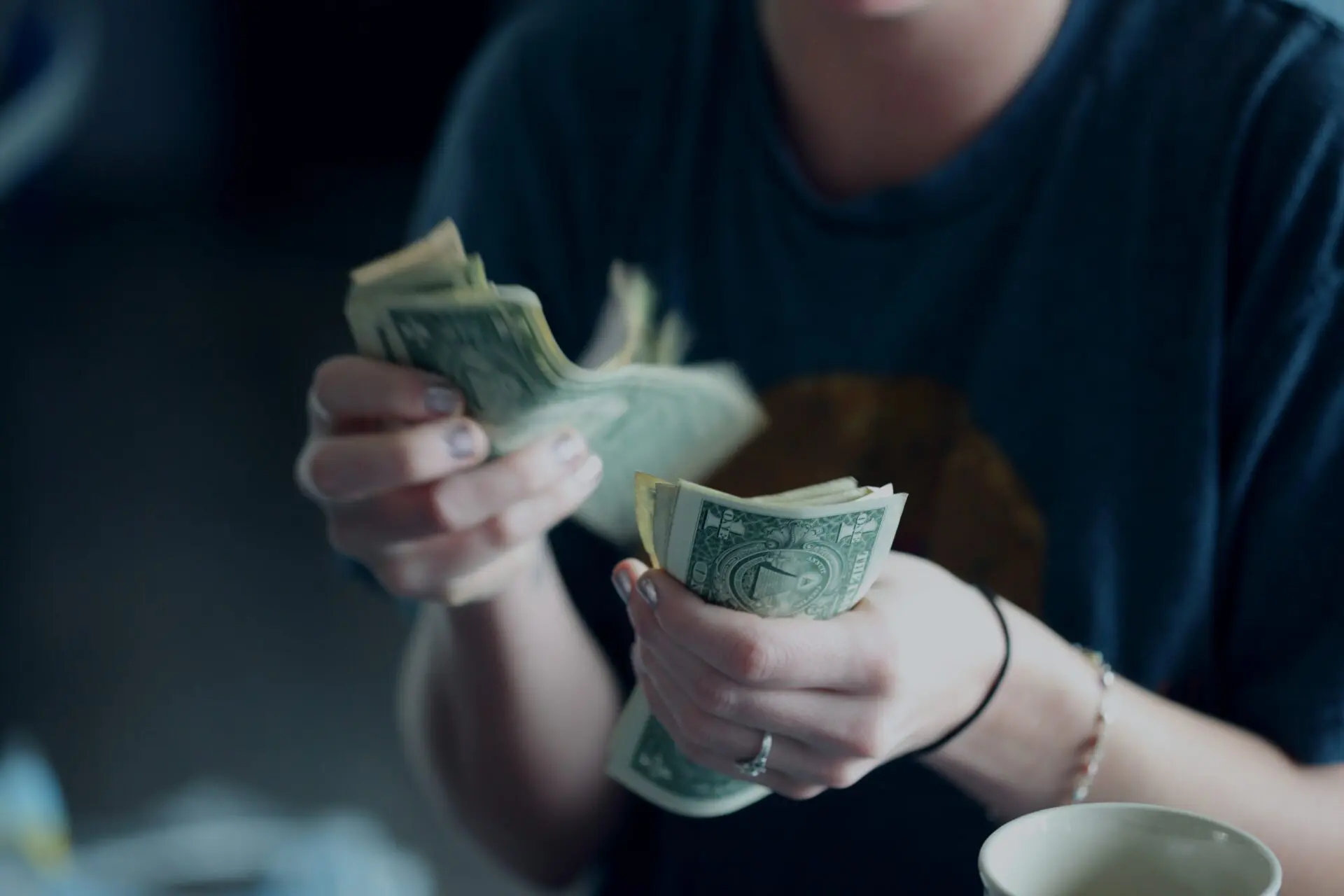 Counting Money - Photo by Alexander Mils on Unsplash  